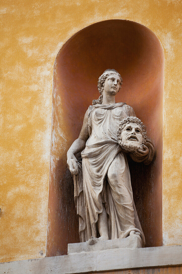 'Theatrical statue on a building framed in an arch;Ravenna emilia-romagna italy'