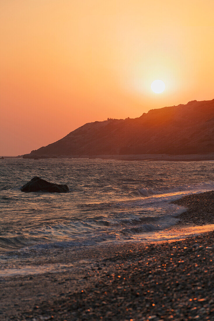 'Waves coming into the shore and view of the coastline at sunset;Aphrodite bay, cyprus'