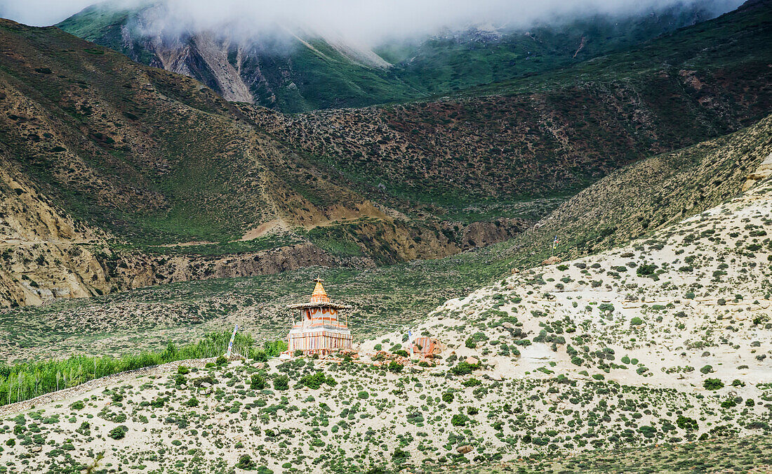 'A distant chorten on a mountain slope along the route from ghemi to lo manthang;Upper mustang nepal'