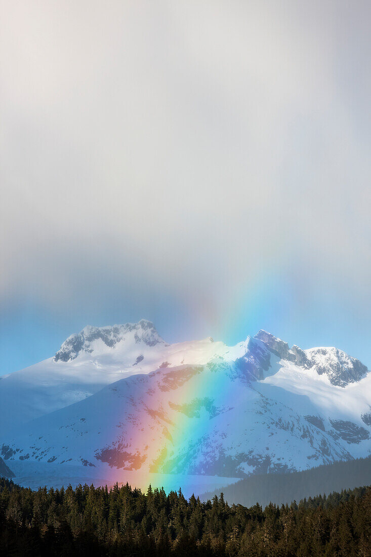 'Rainbows and intermittent showers in tongass national forest with herbert glacier beyond amalga harbor area in spring;Juneau alaska united states of america'