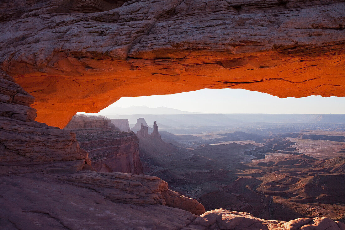 'The lower arch glows a brilliant orange as the sun rises over mesa arch in canyonlands national park;Moab utah united states of america'