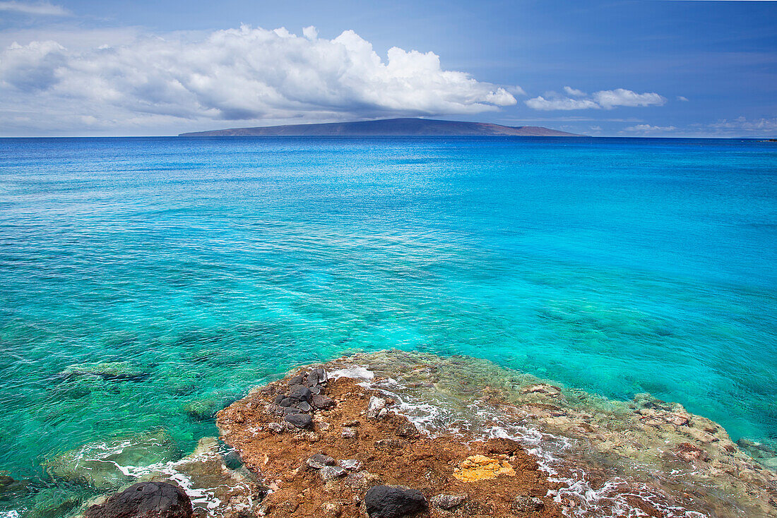 'A view of la perouse bay with clear water and coral with kooholawae in the distance;Maui hawaii united states of america'