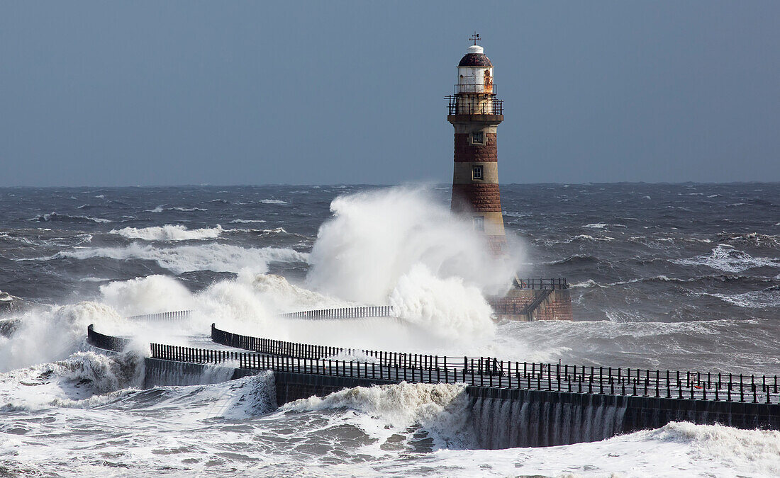 'Waves crashing into a lighthouse on the coast;Sunderland Tyne and Wear England'