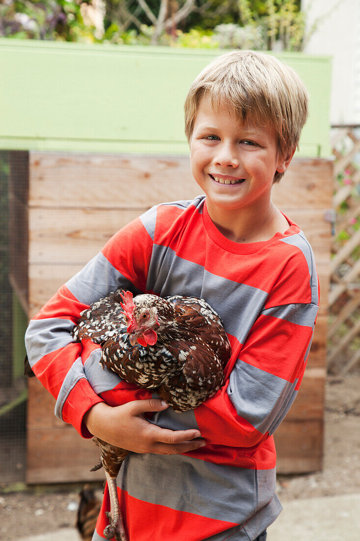 'A boy holds a chicken;San francisco california united states of america'