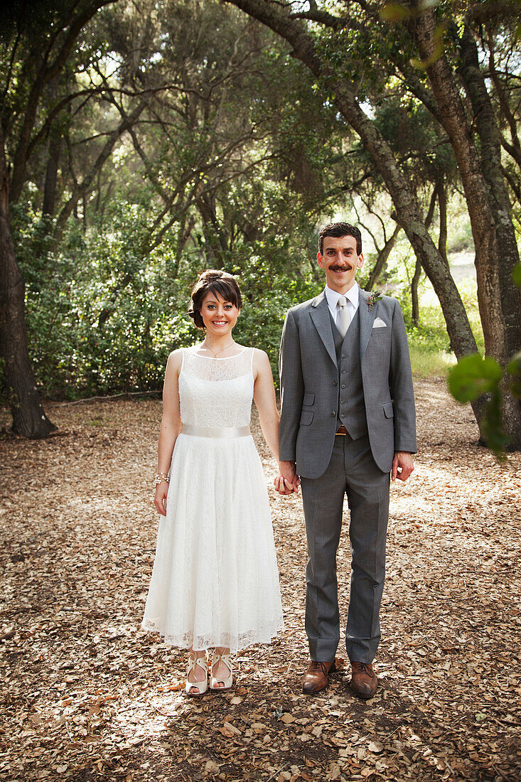 'Portrait of a couple standing in a park in formal wear;California united states of america'
