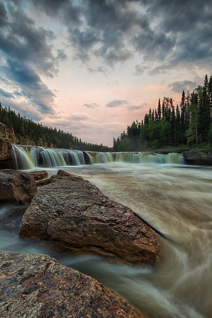 'The Trout River flows over Sambaa Deh Falls in Sambaa Deh Territorial Park; Northwest Territories, Canada'