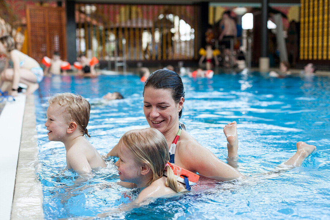 Mother with children in a swimming bath, Bad Oeynhausen, North Rhine-Westphalia, Germany