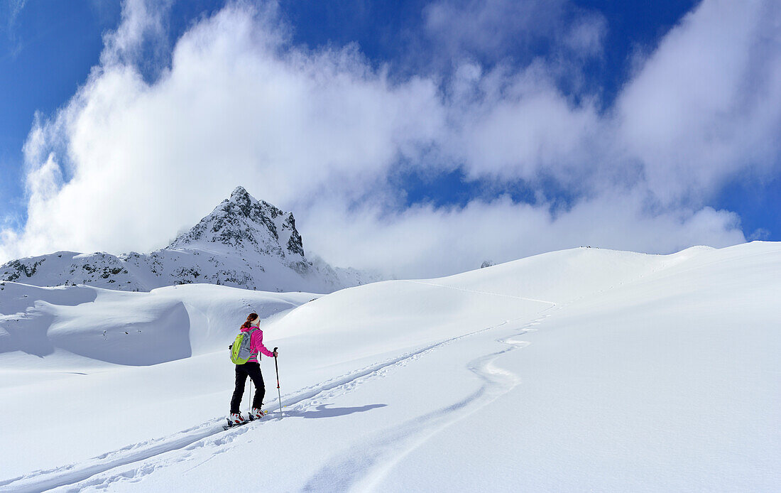 Female ski tourer ascending to Piz Sasuret, Piz Sasuret, Albula Alps, Engadin, Canton of Graubuenden, Switzerland