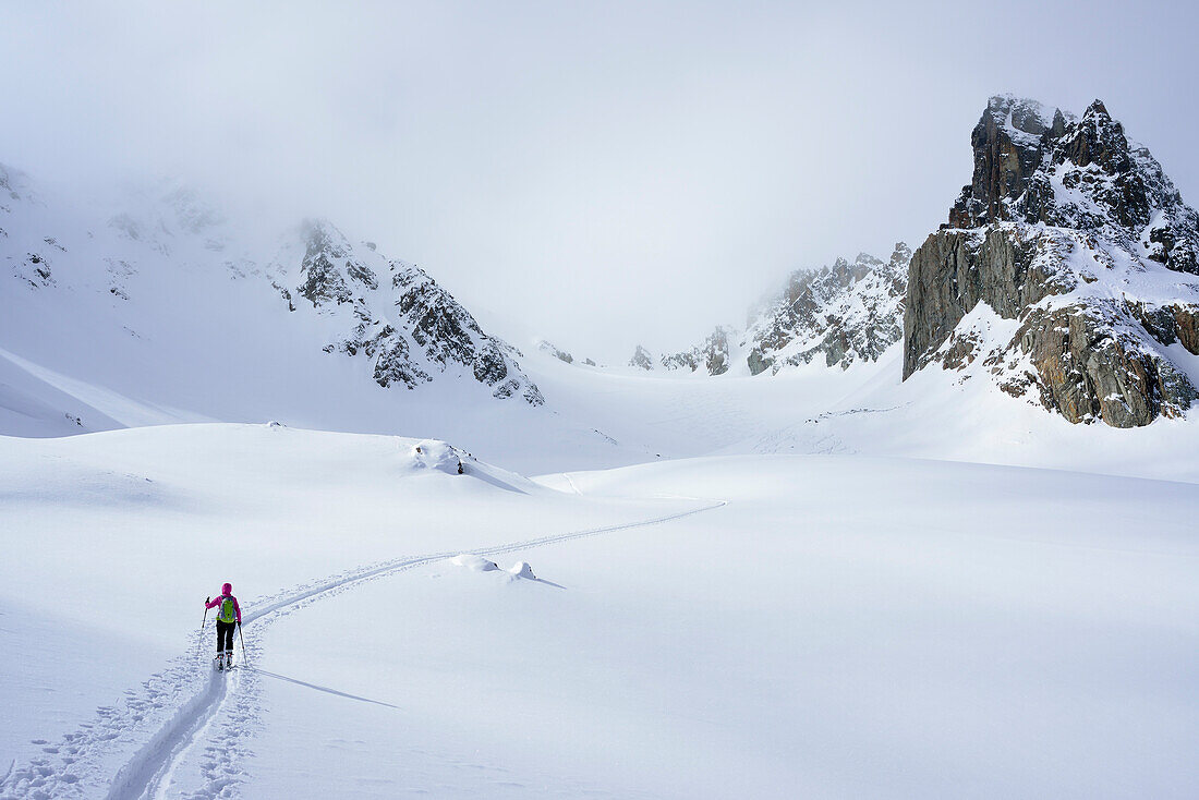 Female ski tourer ascending to Piz Sasuret, Piz Sasuret, Albula Alps, Engadin, Canton of Graubuenden, Switzerland