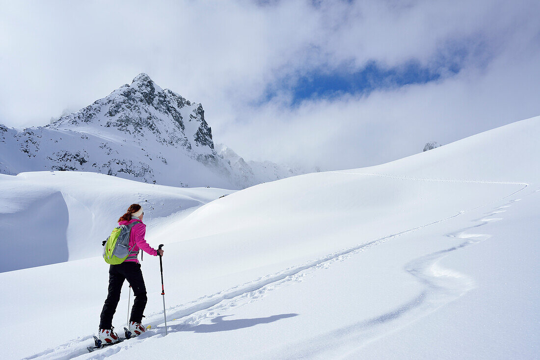 Female ski tourer ascending to Piz Sasuret, Piz Sasuret, Albula Alps, Engadin, Canton of Graubuenden, Switzerland