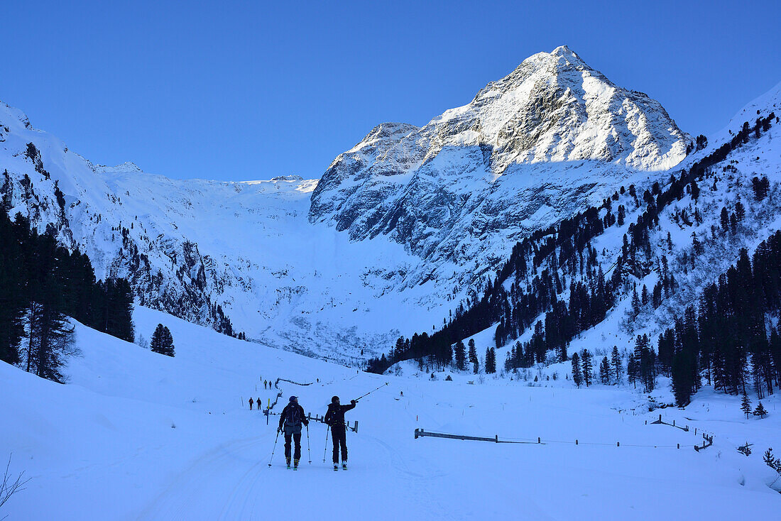 Two back-country skiers ascending to Lisenser Fernerkogel, Sellrain, Stubai Alps, Tyrol, Austria