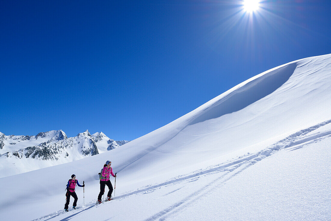 Two female back-country skiers ascending to Eiskoegele, Obergurgl, Oetztal Alps, Tyrol, Austria