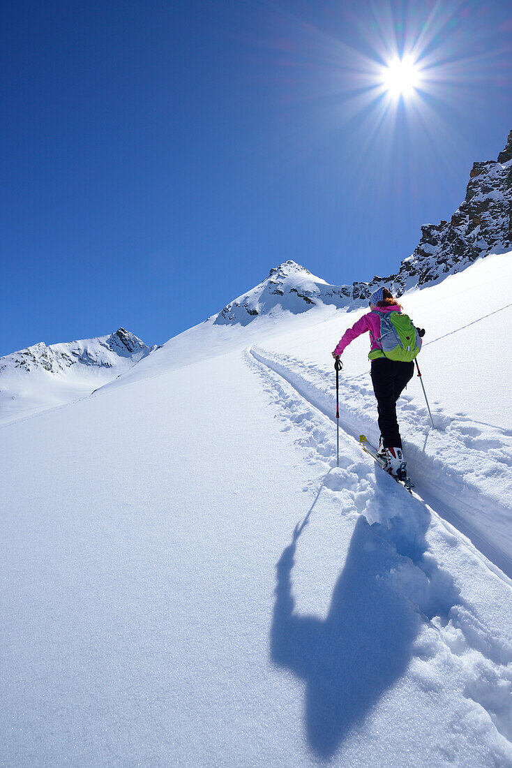 Female back-country skier ascending to Eiskoegele, Obergurgl, Oetztal Alps, Tyrol, Austria