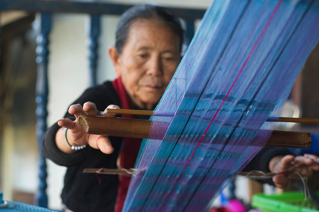 Elderly Palaung woman weaving near Kyaing Tong, Kentung, Shan State, Myanmar, Burma