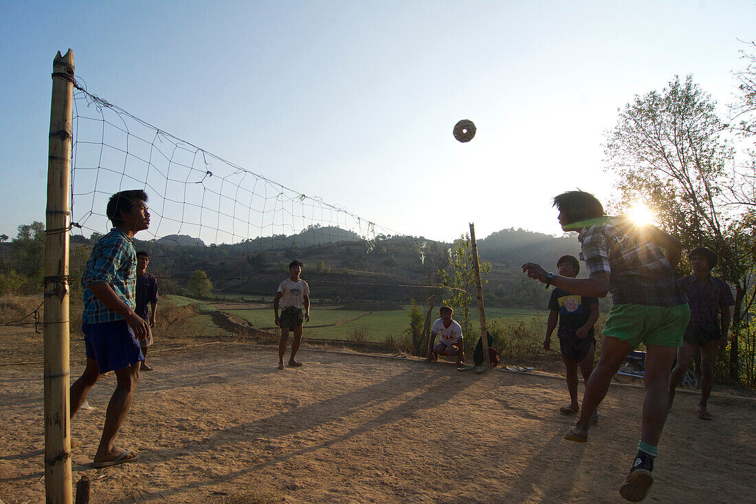 Trekking from Kalaw to Inle Lake, men playing Ching Loong, Sepak Takraw in a Danu village, Shan State, Myanmar, Burma