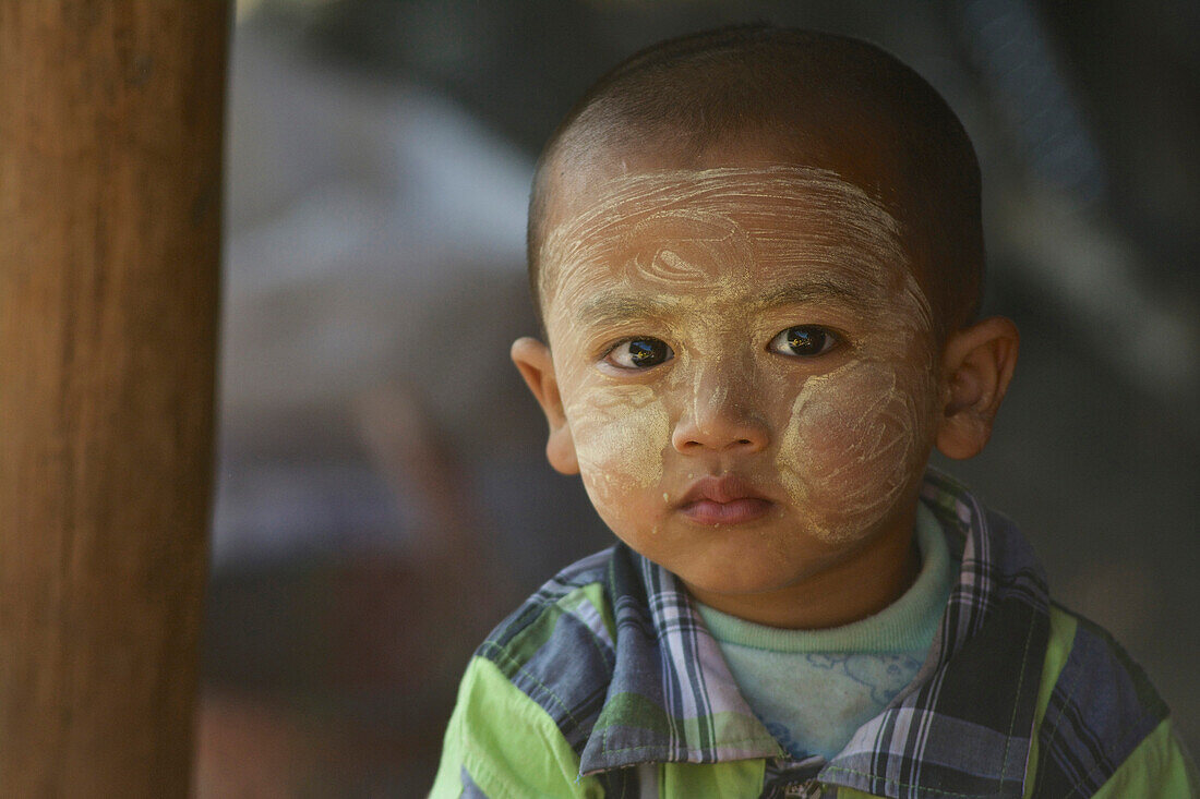 Child with tanaka Paste in his face at a market near Loikaw, Kayah State, Karenni State, Myanmar, Burma, Asia