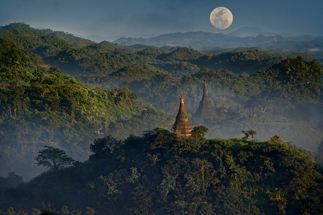 Full moon in Burma, view above hill and pagoda in the morning mist at Mrauk U, Myohaung north of Sittwe, Akyab, Rakhaing State, Arakan, Myanmar, Burma
