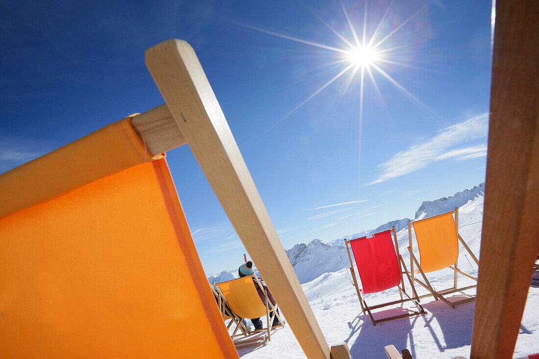 Deck chairs in snow, Zugspitze, Upper Bavaria, Germany