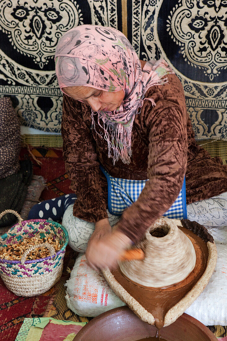 woman producing argan oil, Essaouira, Morocco