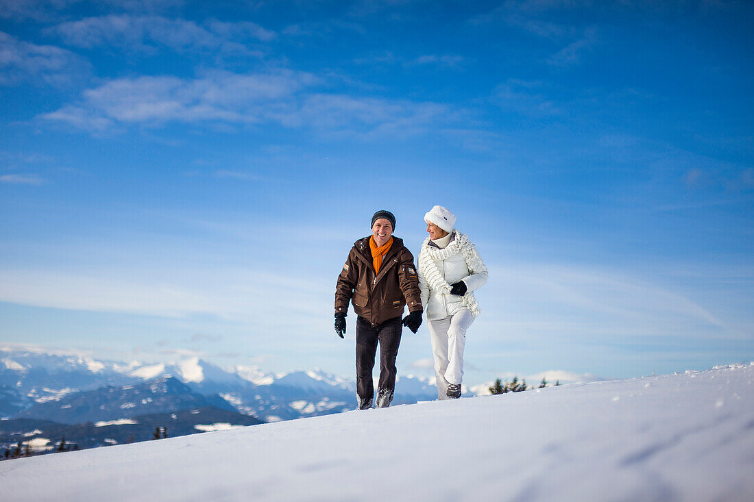 Couple walking through snow, Zirbitzkogel, Muehlen, Styria, Austria