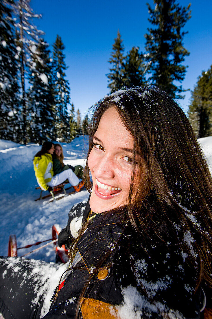 Young women tobogganing, Kreischberg, Murau, Styria, Austria