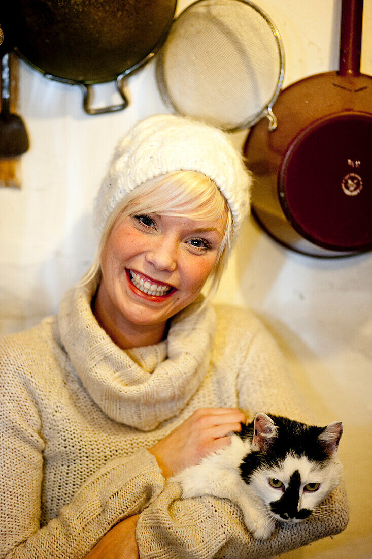 Young woman petting a cat