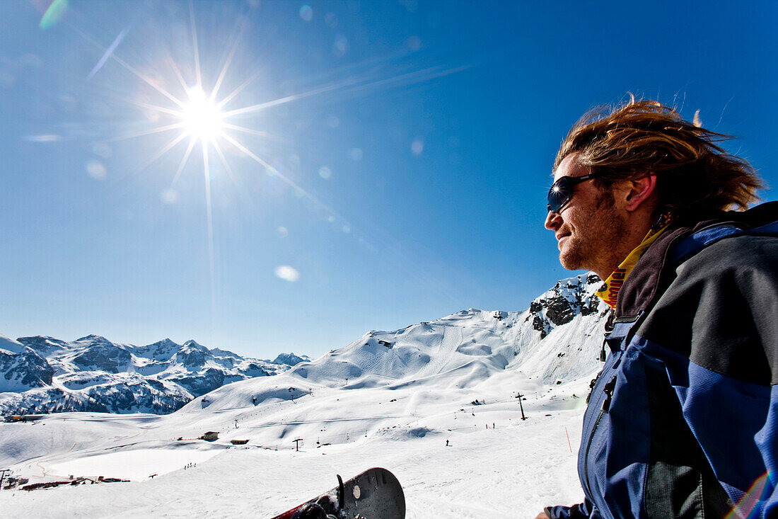 Snowboarder blickt über Piste, Obertauern, Salzburg, Österreich