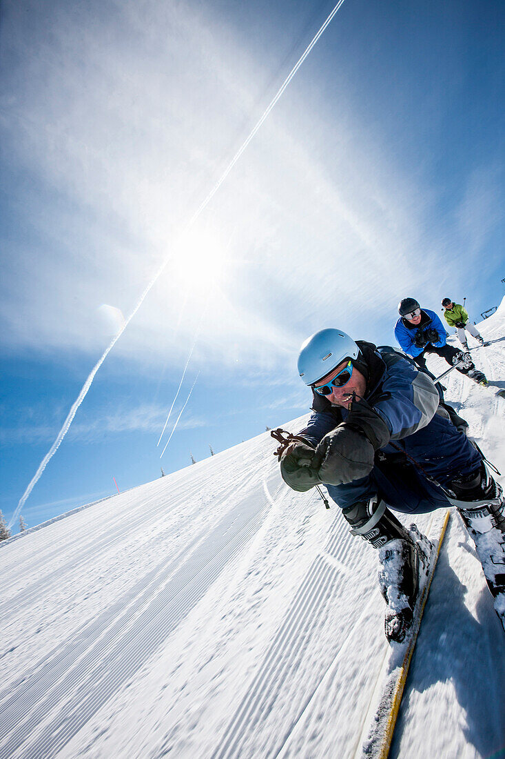 Three skiers on slope, Fageralm, Salzburg, Austria