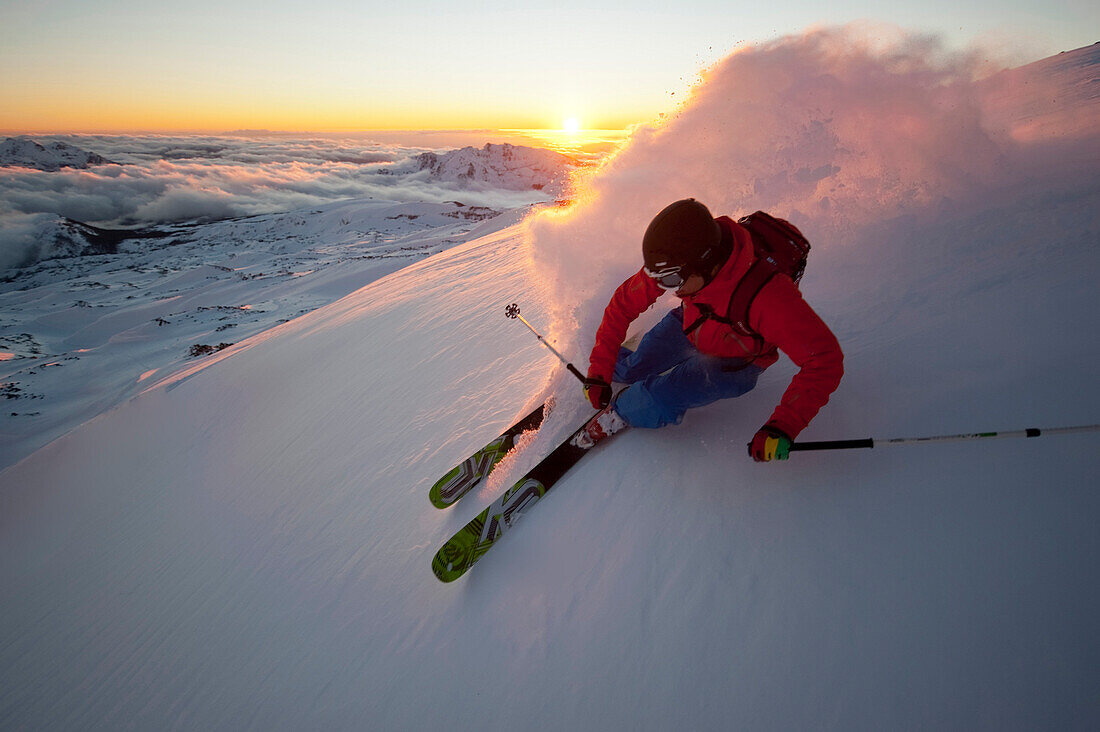 Skier downhill skiing in sunset, Nevados de Chillan, Bio-Bio Region, Chile