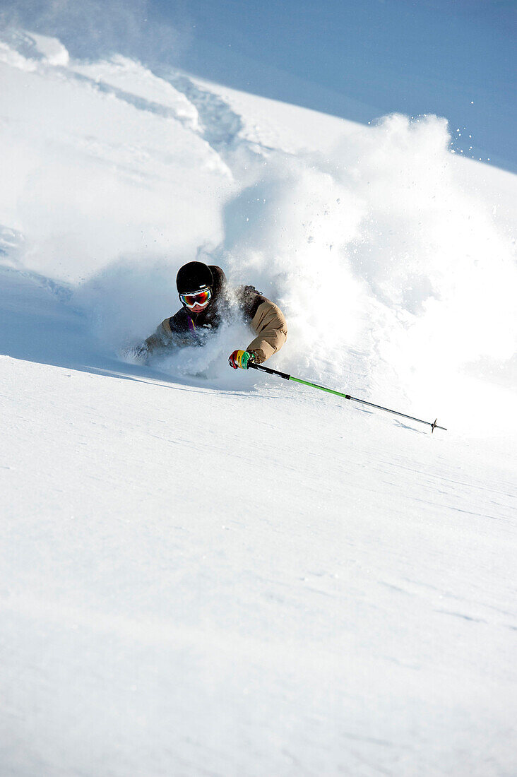 Skier downhill skiing in powder snow, Hintertux Glacier, Zillertal, Tyrol, Austria