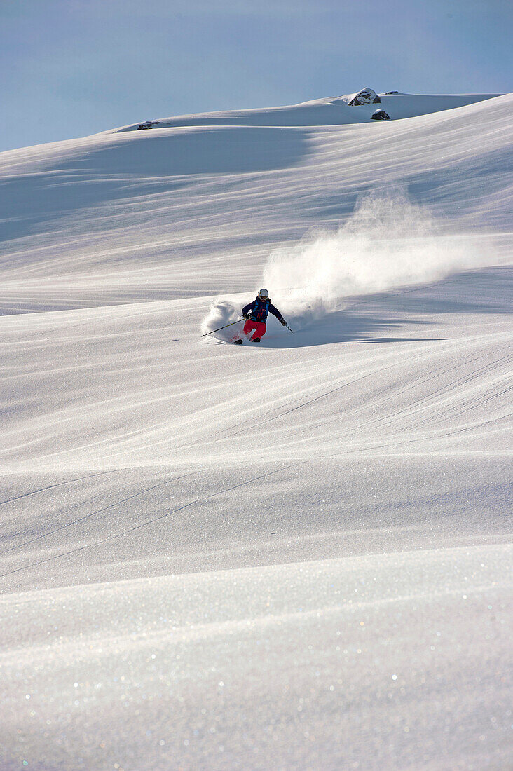 Skier downhill skiing in powder snow, Hochfugen, Fugenberg, Zillertal, Tyrol, Austria