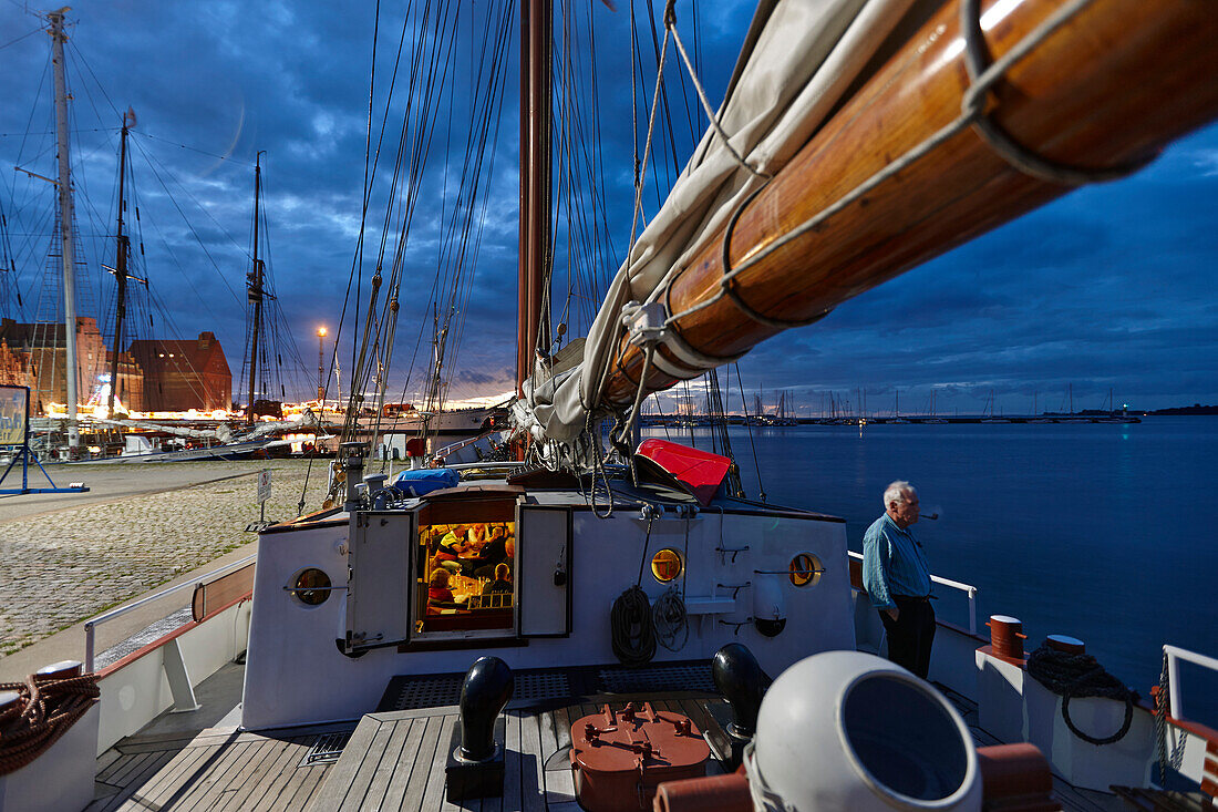 Sailing ship at landing pier in harbor in the evening, Stralsund, Mecklenburg-Western Pomerania, Germany