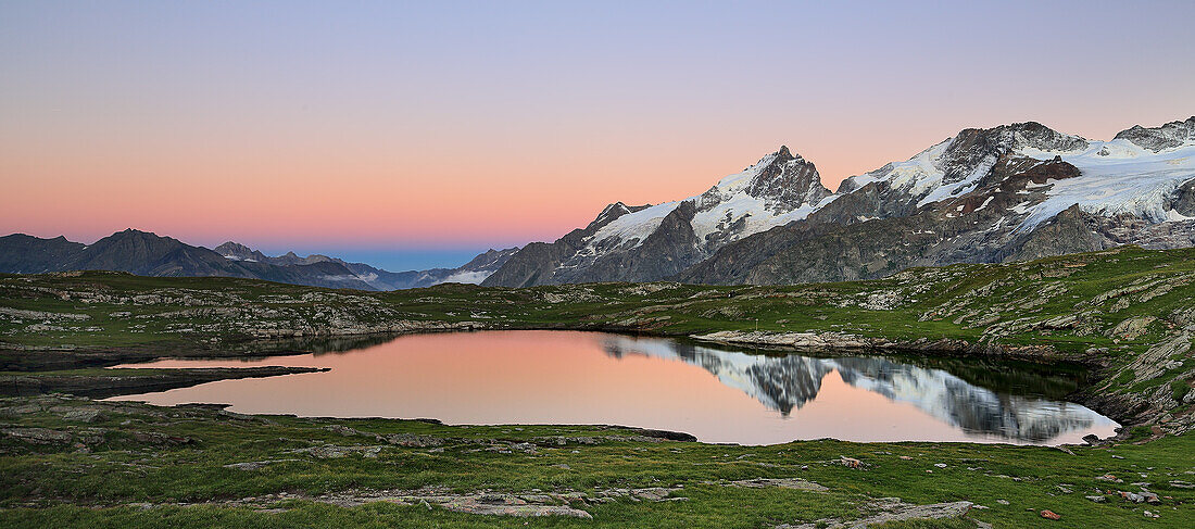 Meije and mt. Rateaux reflecting into black lake near La Grave, France.