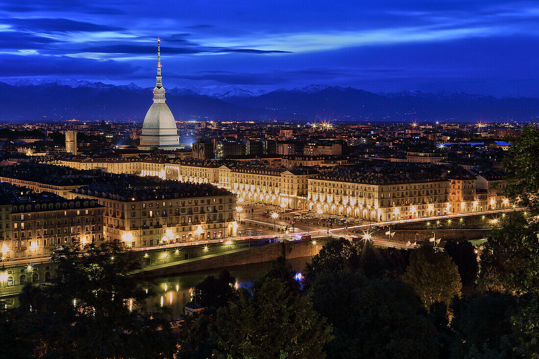 The town of Torino lighting before night, with the Mole Antonelliana