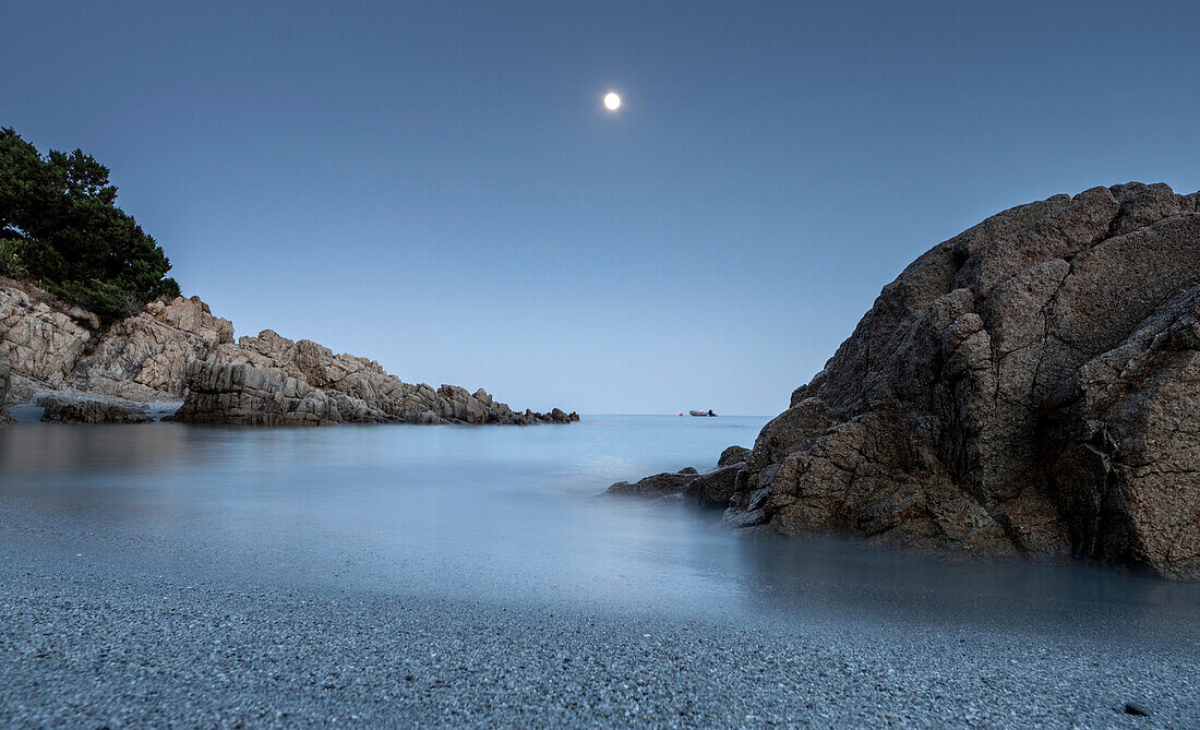 A full moon night, the pleasant blue hues that give a feeling of peace, this beach of Cala Liberotto, Sardinia