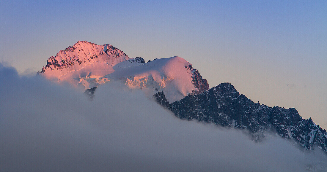 Clouds and a peak in the sunset's lights , French alps