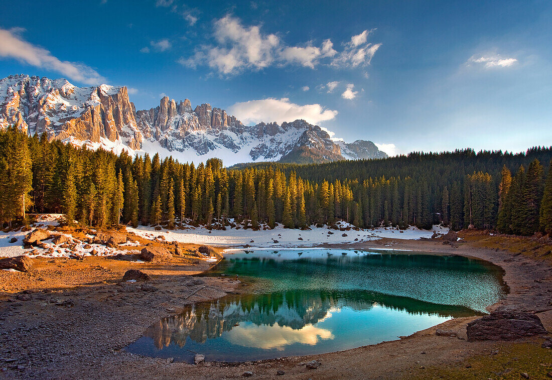 The Carezza lake, with fir forests and the Latemar ridge in the background, under the sunset's light, Ega's valley, Dolomites
