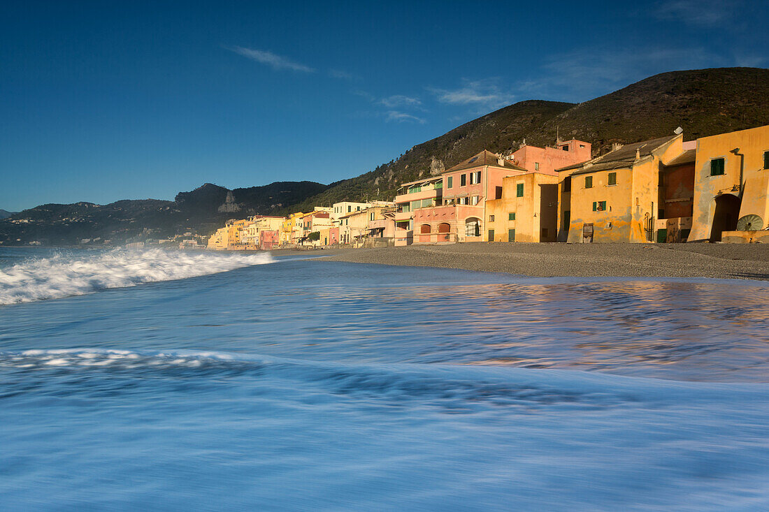 Sunrise in the fisherman village near at the sea in Varigotti town, La Spezia, Liguria, Italy. Beautiful vision of the waves near the house in the beach