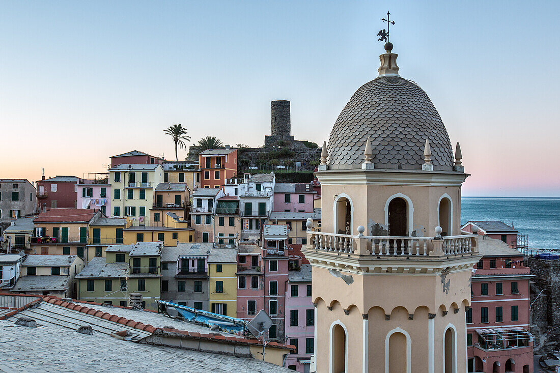 A detail of the church of Vernazza, one of the prettiest village of the Cinque Terre. In the background, pastel-colored houses overlooking the little natural harbor make Vernazza simply enchanting, Cinque Terre National Parc, Liguria, Italy