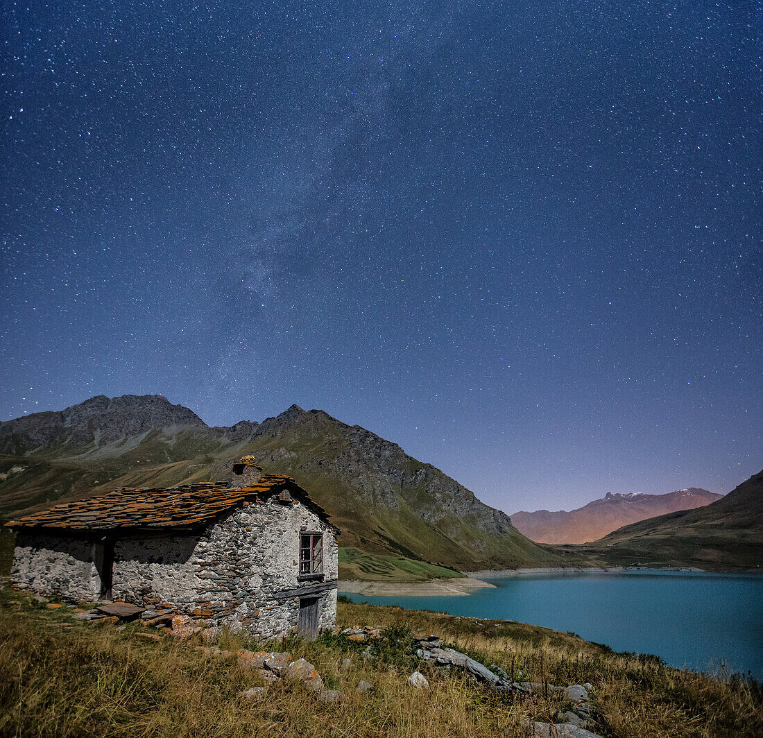 Panoramic shot showing the Milky Way over Lake Moncenisio, Alps, France.