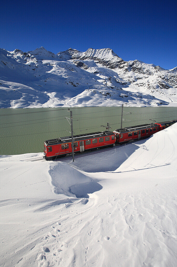 The Bernina Express , Unesco World Heritage at the Bernina pass close to Lake Bianco, Bernina pass, Alps, Engadin, Canton Graubuenden, Switzerland.
