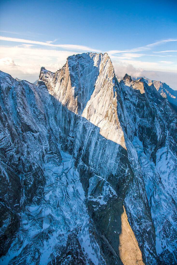 The clean granite of the impressive northeast face of the Piz Badile overlooking the Bondasca valley from the helicopter. It is a mountain of the Bregaglia range in the Swiss canton of Graubünden and the Italian region of Lombardy, the border between the 