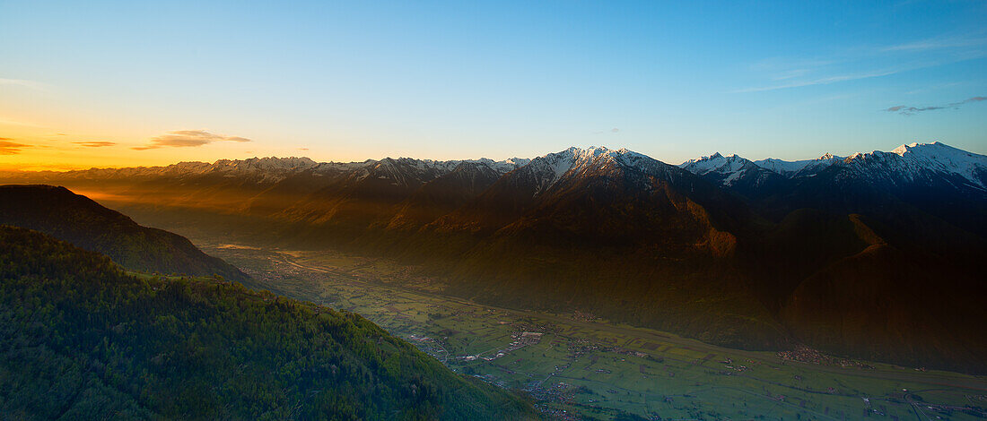 A beam of light illuminates the valley during a sunrise shoot in the Alps