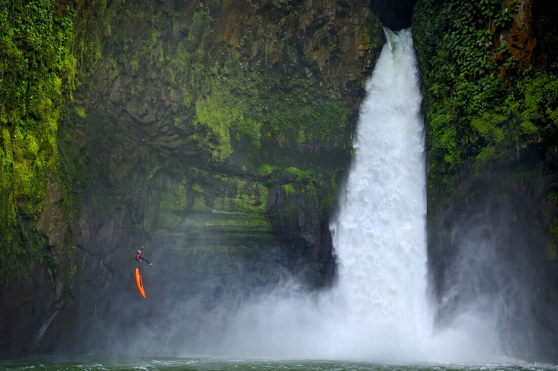 A man rappels down a huge cliff next to a waterfall on the Alseseca River  in the Veracruz region of Mexico.