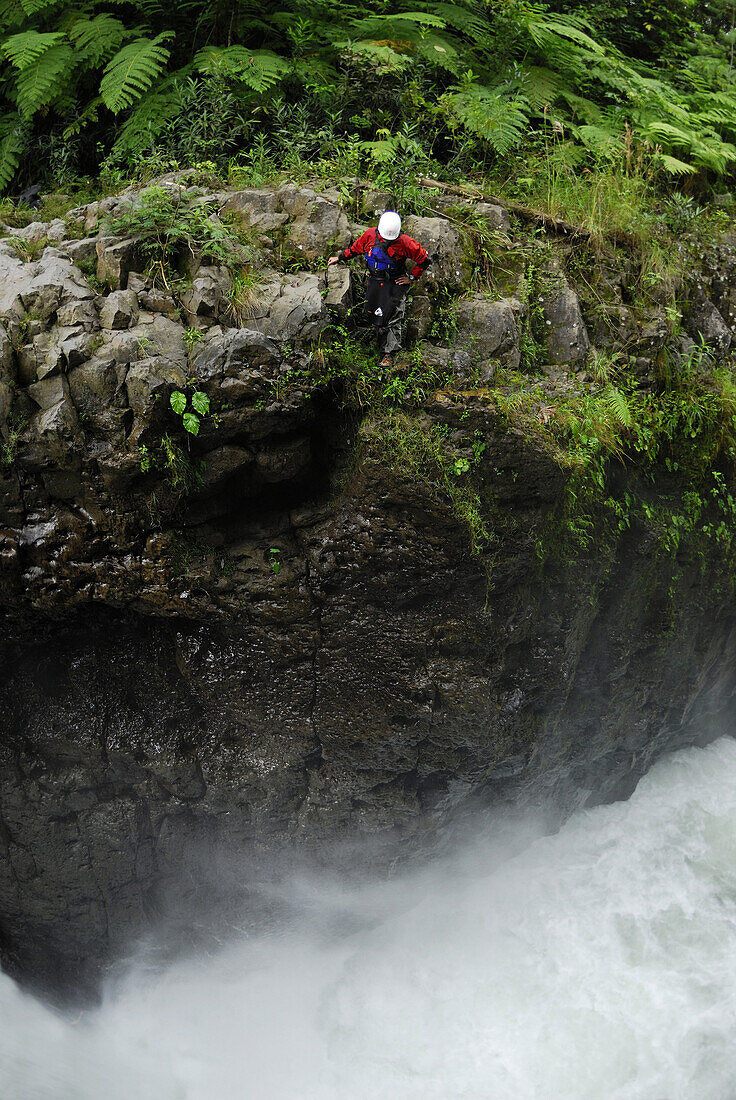 A man scouts a waterfall, while kayaking on the Alseseca River  in the Veracruz region of Mexico.