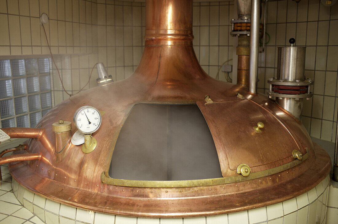 Smoked malt mixes with water in a copper vat at the Bamberg brewpub Spezial, run by Christian Merz and his family.