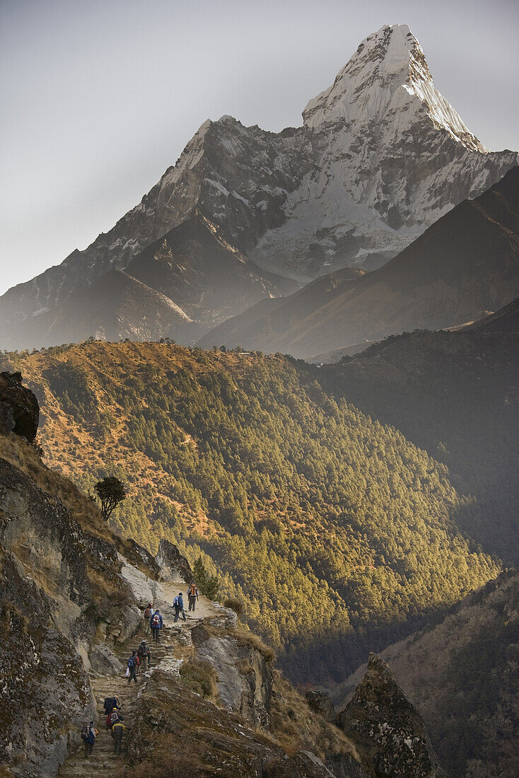 A group of trekkers are dwarfed by the impressive bulk of Ama Dablam 6812m, as they make their way to Everest Base Camp in Nepal on November 1st 2008.