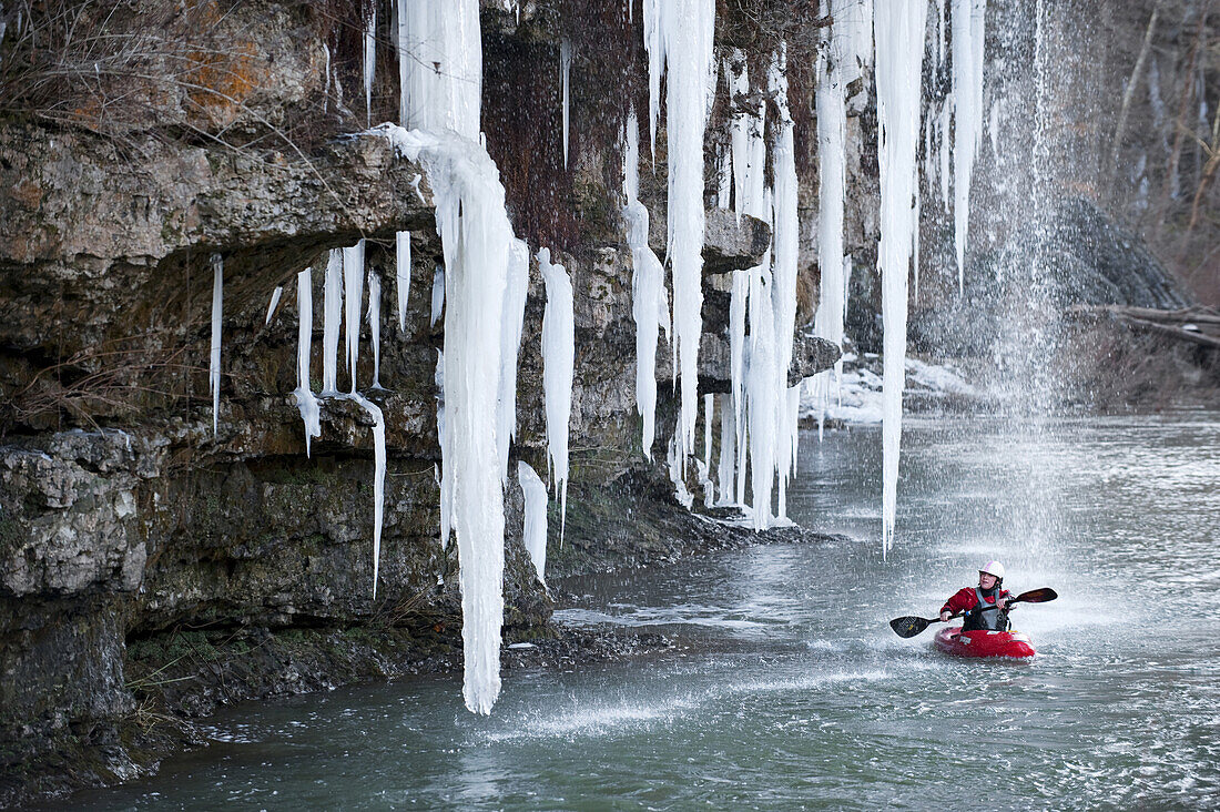 Emily Jackson paddles near large hanging icicles on the Caney Fork in Rock Island, TN.