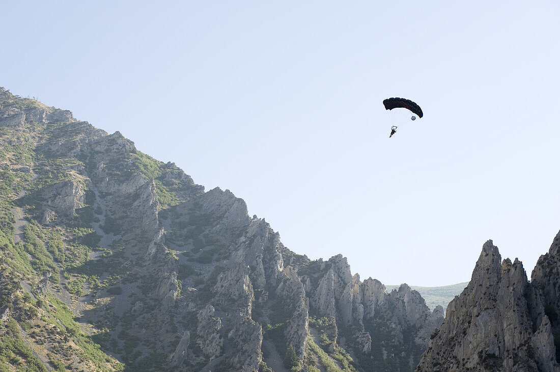 A base jumper opens up their chute after a jump near Spanish Fork in Utah.