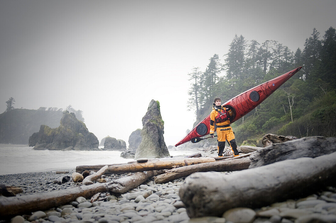 Nick Blakey with a Wilderness Systems Tempest kayak on Ruby Beach, Olympic National Park, Washington, USA, 7 October 2008.